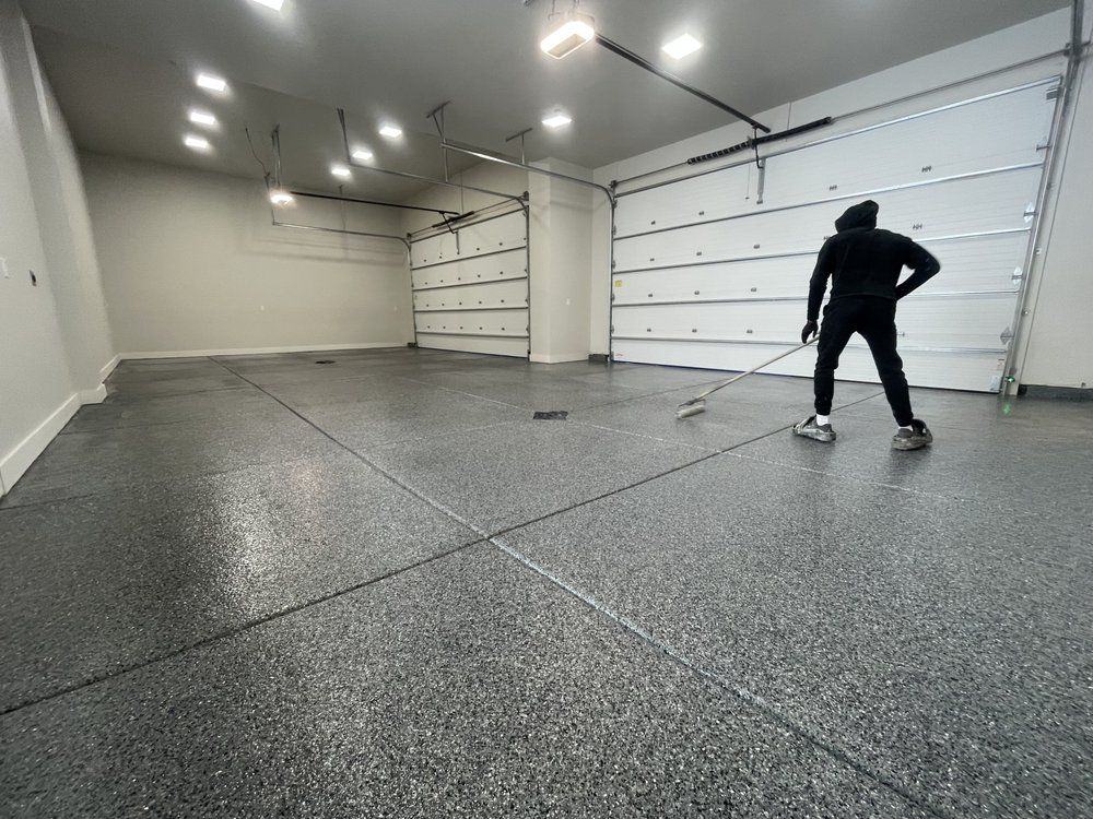 Crew finishing a gray full-flake garage floor coating